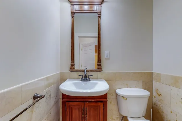 a bathroom with a toilet sink and mirror