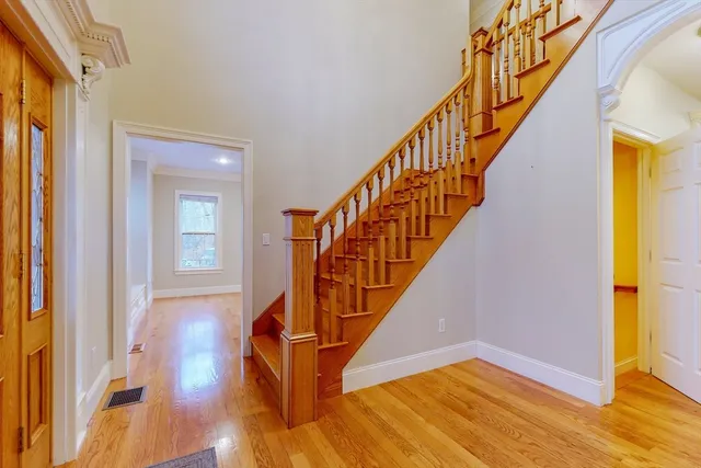 a view of entryway and hall with wooden floor