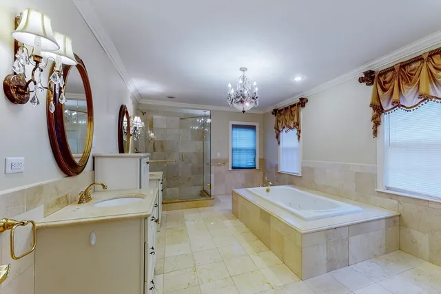 a spacious bathroom with a sink a large mirror and a bathtub