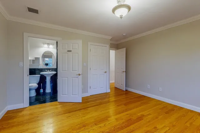 a view of a room with wooden floor and cabinet