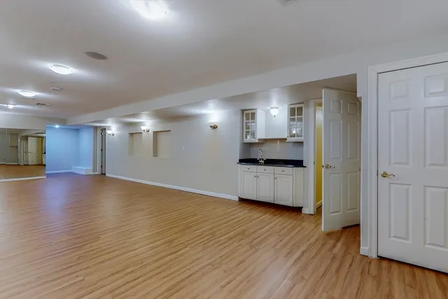 a view of a kitchen with a sink and a refrigerator