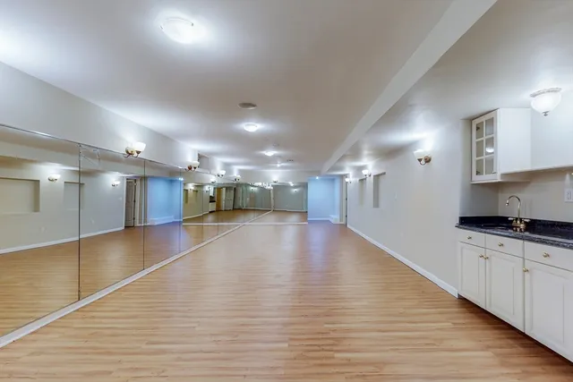 a view of a kitchen with a sink and cabinets