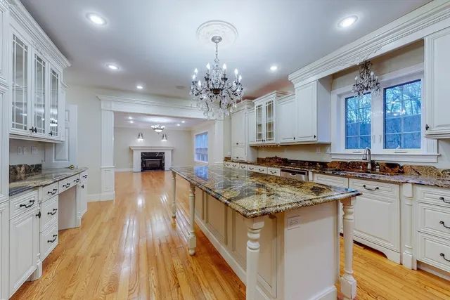 a kitchen with stainless steel appliances granite countertop a sink stove and cabinets