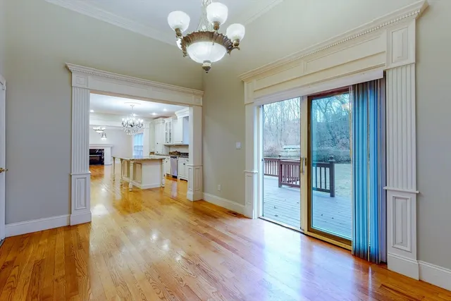 a view of a kitchen with wooden floor and a large window
