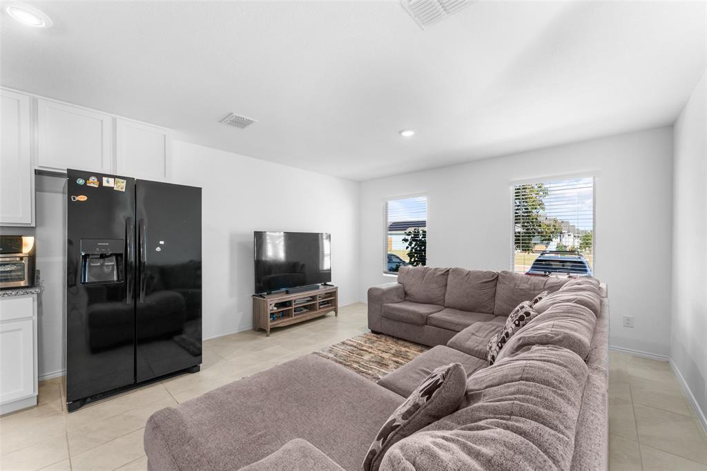 241 Thresher Lane Princeton, TX 75407 - Photo 7 of 33 a living room with furniture and a flat screen tv