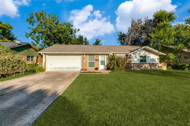 a front view of a house with a garden and porch