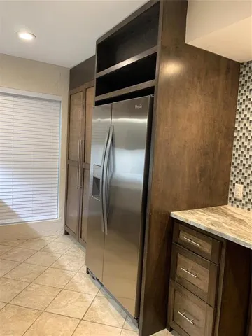 a kitchen with a refrigerator and a sink