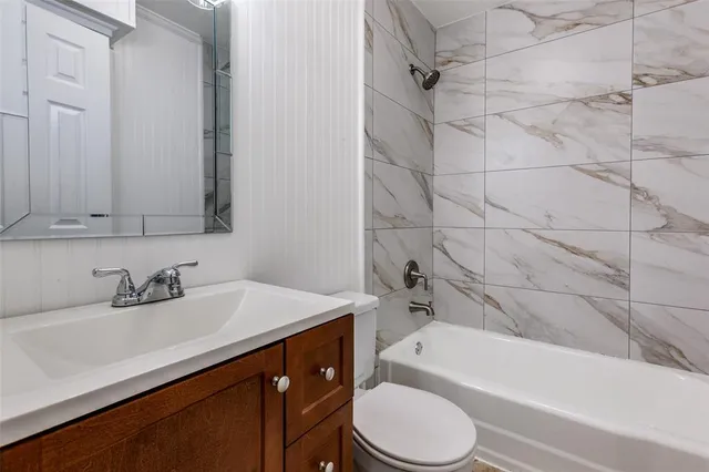 a bathroom with a sink a toilet and bathtub