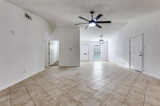 a view of a livingroom with a ceiling fan and entryway