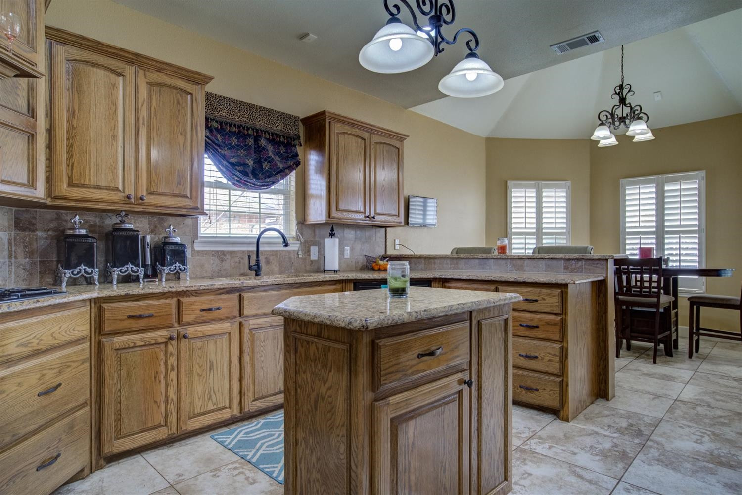 5904 110th Street Lubbock, TX 79424 - Photo 15 of 50 a kitchen with cabinets appliances and a sink
