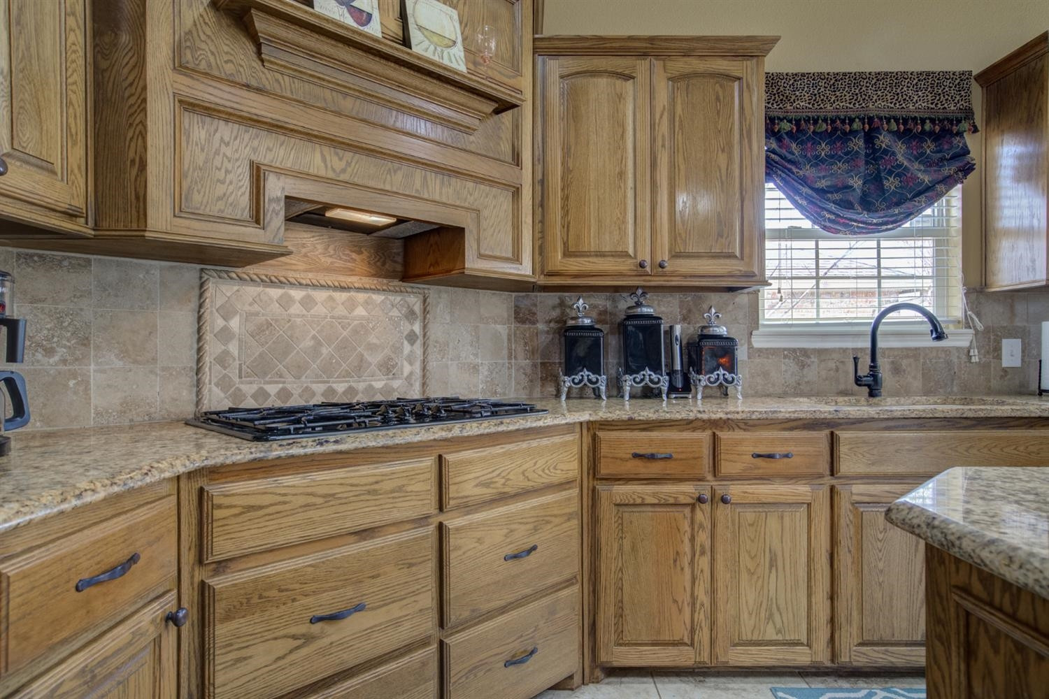 5904 110th Street Lubbock, TX 79424 - Photo 16 of 50 a kitchen with granite countertop cabinets stainless steel appliances and a sink