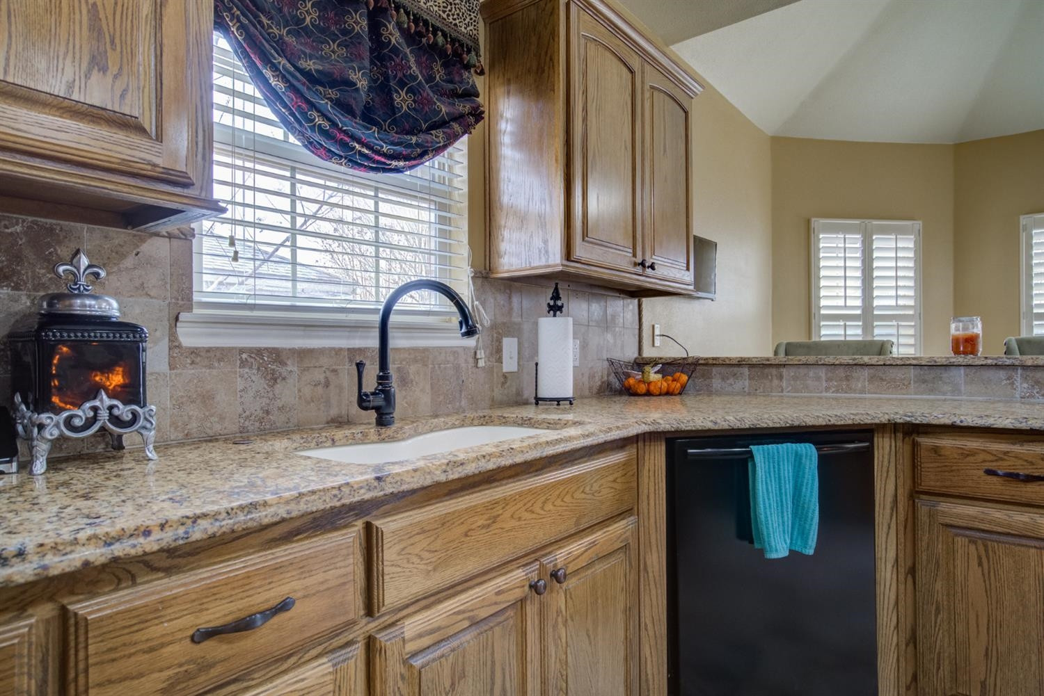5904 110th Street Lubbock, TX 79424 - Photo 17 of 50 a kitchen with stainless steel appliances granite countertop a sink a stove and cabinets