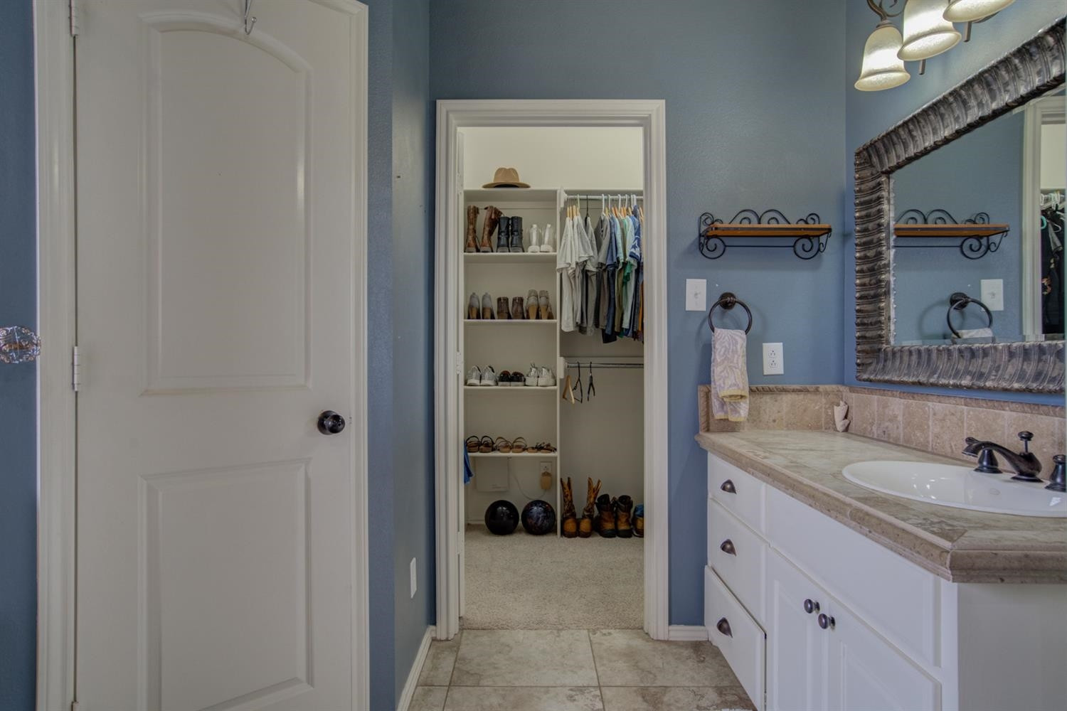 5904 110th Street Lubbock, TX 79424 - Photo 29 of 50 a bathroom with a sink and a mirror