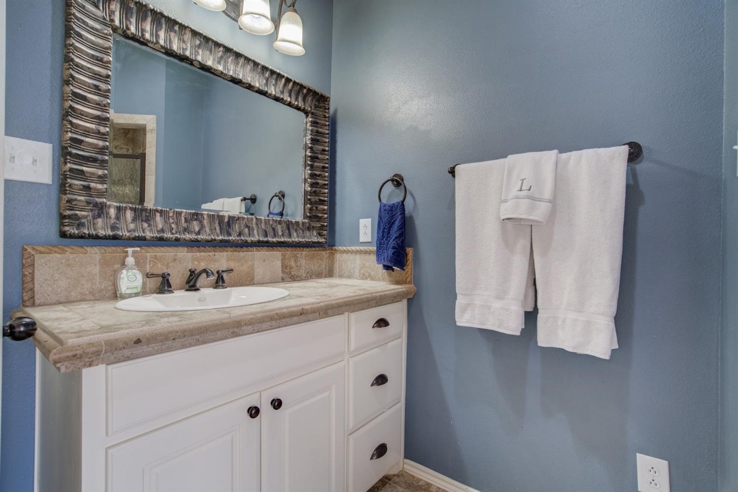 5904 110th Street Lubbock, TX 79424 - Photo 30 of 50 a bathroom with a sink and a mirror