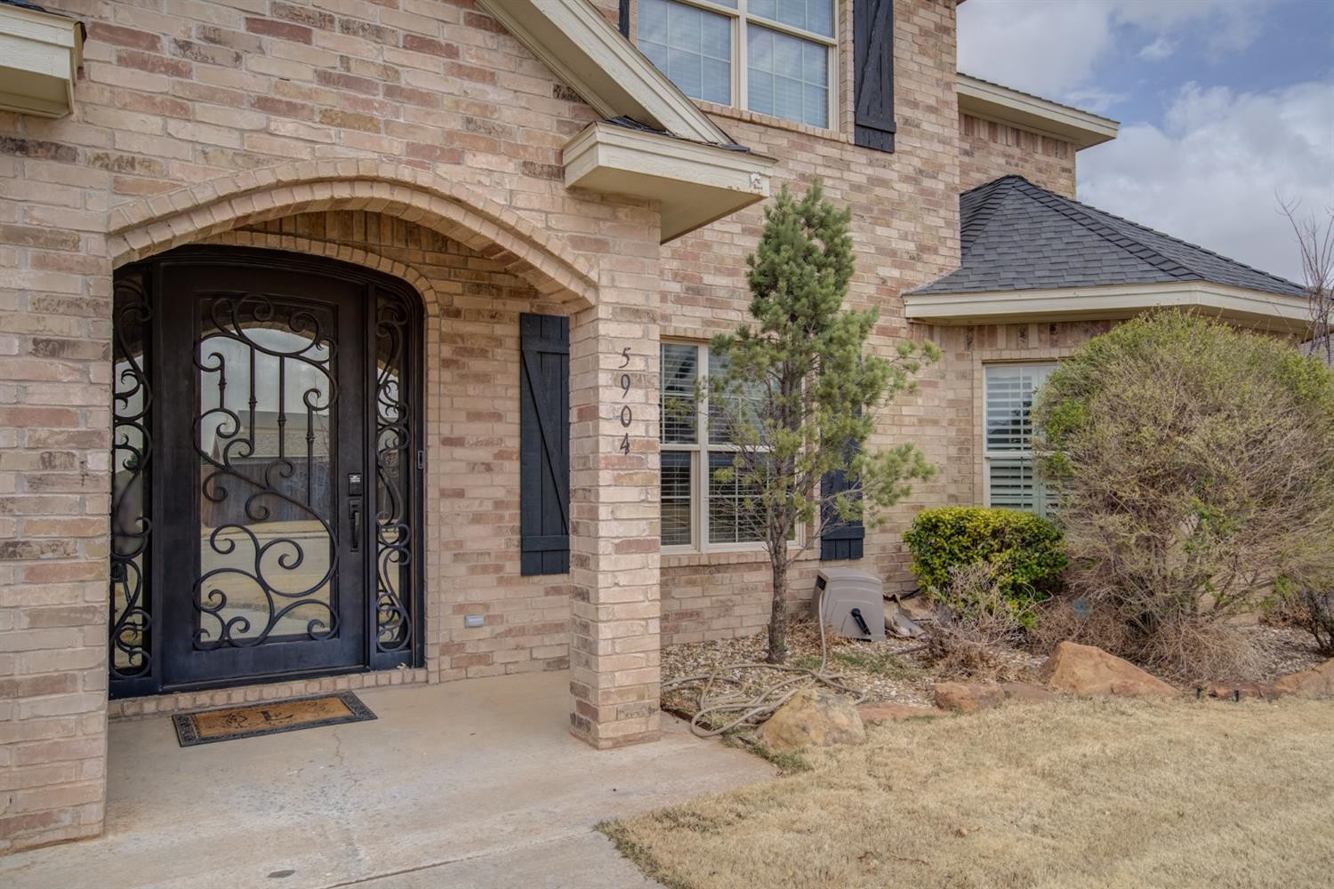 5904 110th Street Lubbock, TX 79424 - Photo 3 of 50 a front view of a house with garden