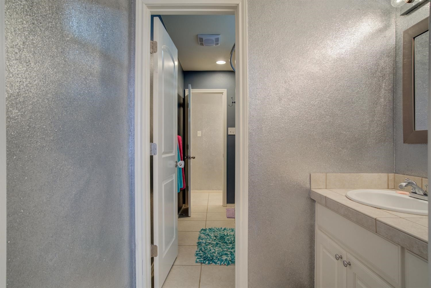 5904 110th Street Lubbock, TX 79424 - Photo 37 of 50 a bathroom with a sink and mirror