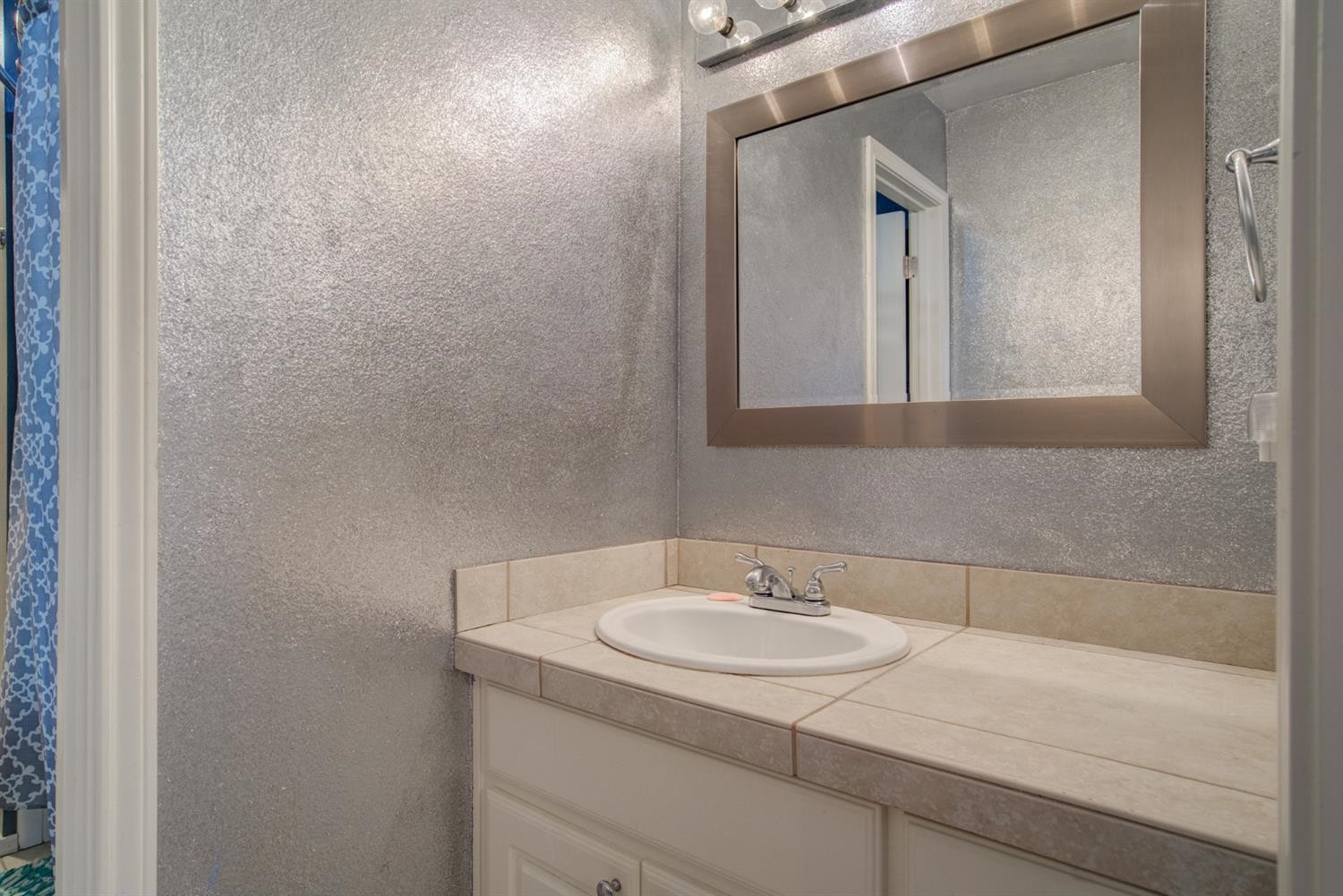 5904 110th Street Lubbock, TX 79424 - Photo 38 of 50 a bathroom with a sink and a mirror