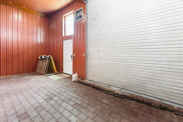 a living room with furniture kitchen view and a window