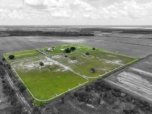 a view of a tennis ground with a lake view