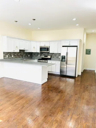 a kitchen with stainless steel appliances a refrigerator and a stove top oven