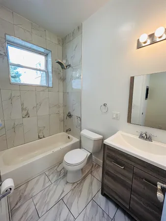 a bathroom with a sink a toilet and bathtub