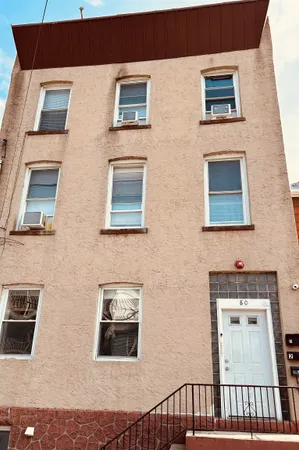 a view of a brick house with many windows