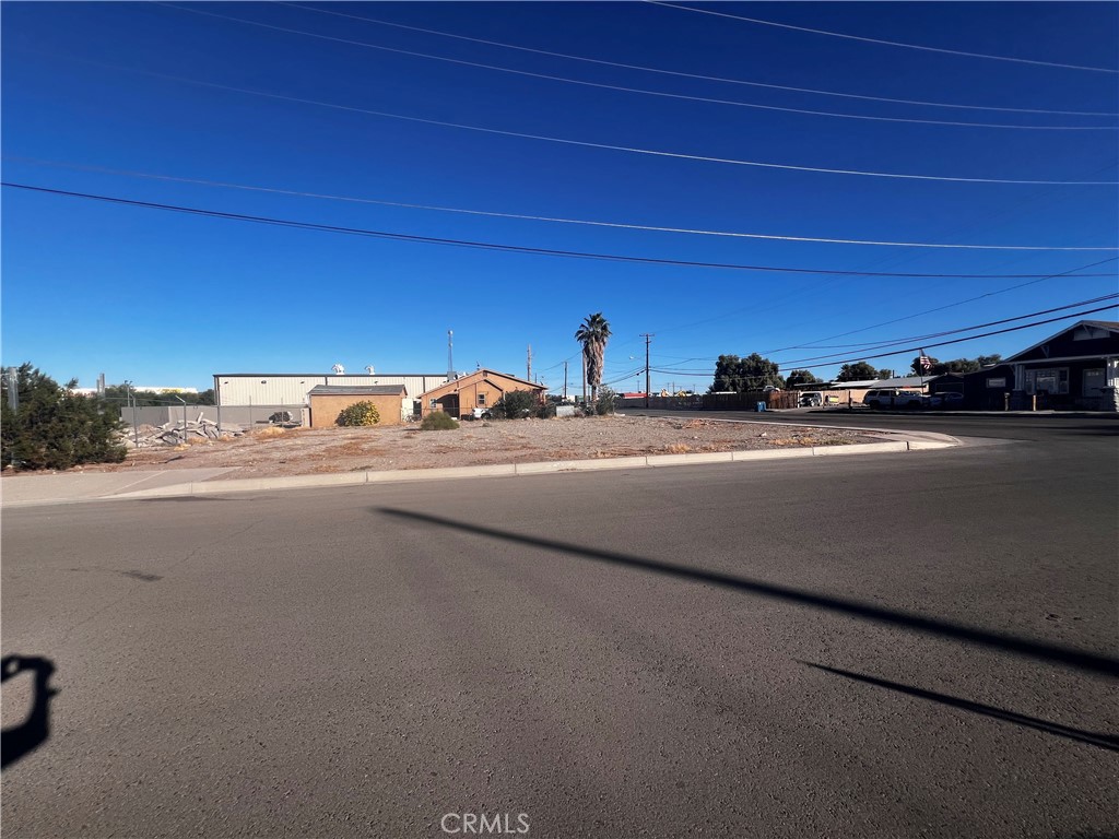 521 Quivera Street Needles, CA 92363 - Photo 2 of 17 a view of a city street with a car parked on the road