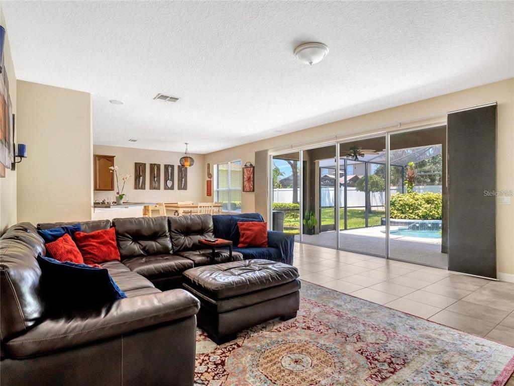 10023 Ians Ridge Road Orlando, FL 32832 - Photo 11 of 60 a living room with furniture and a large window