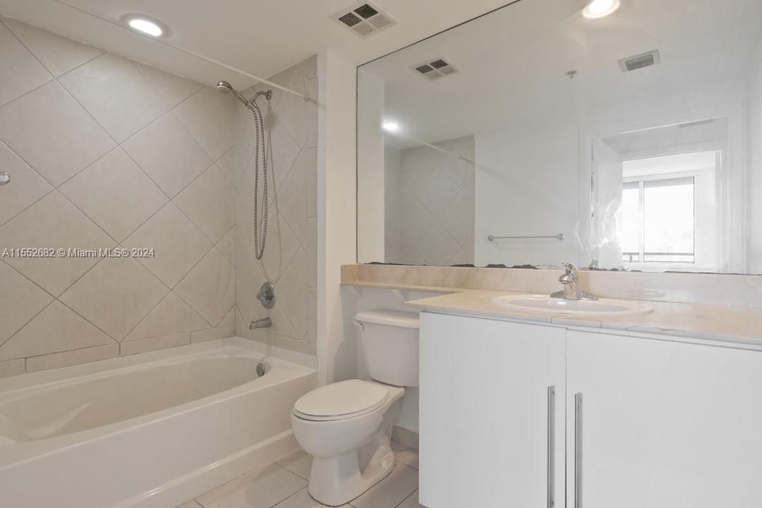 325 South Biscayne Boulevard, Unit 2118 Miami, FL 33131 - Photo 13 of 22 a bathroom with a granite countertop sink a toilet and shower