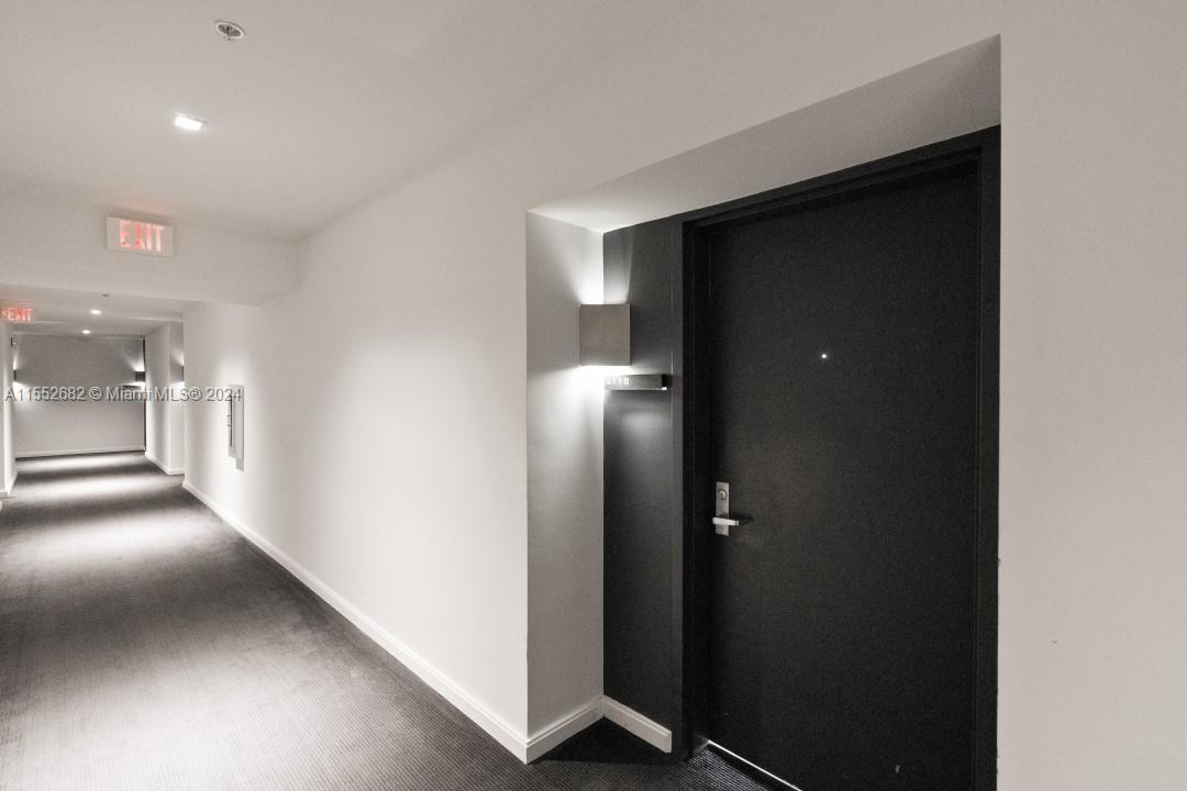 325 South Biscayne Boulevard, Unit 2118 Miami, FL 33131 - Photo 2 of 22 an empty room with wooden floor