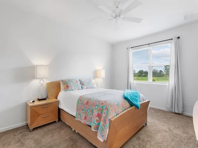 a bed room with a bed and a window