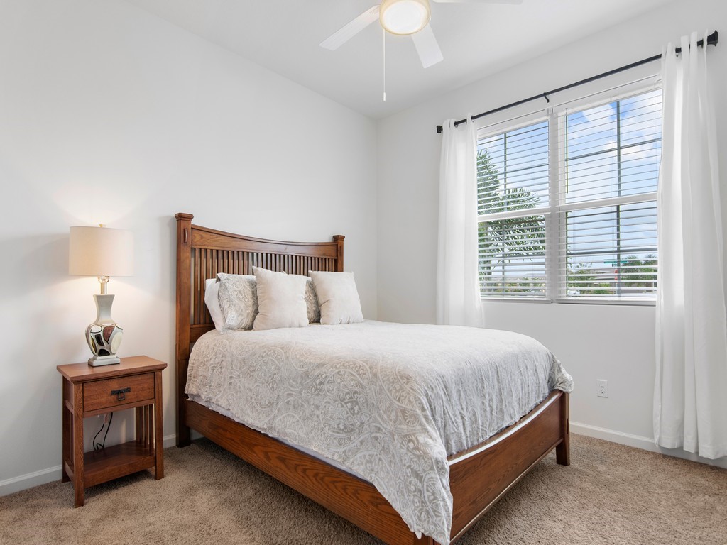 2040 Amazon Way Southwest Vero Beach, FL 32962 - Photo 15 of 35 a bedroom with a bed lamp and a window