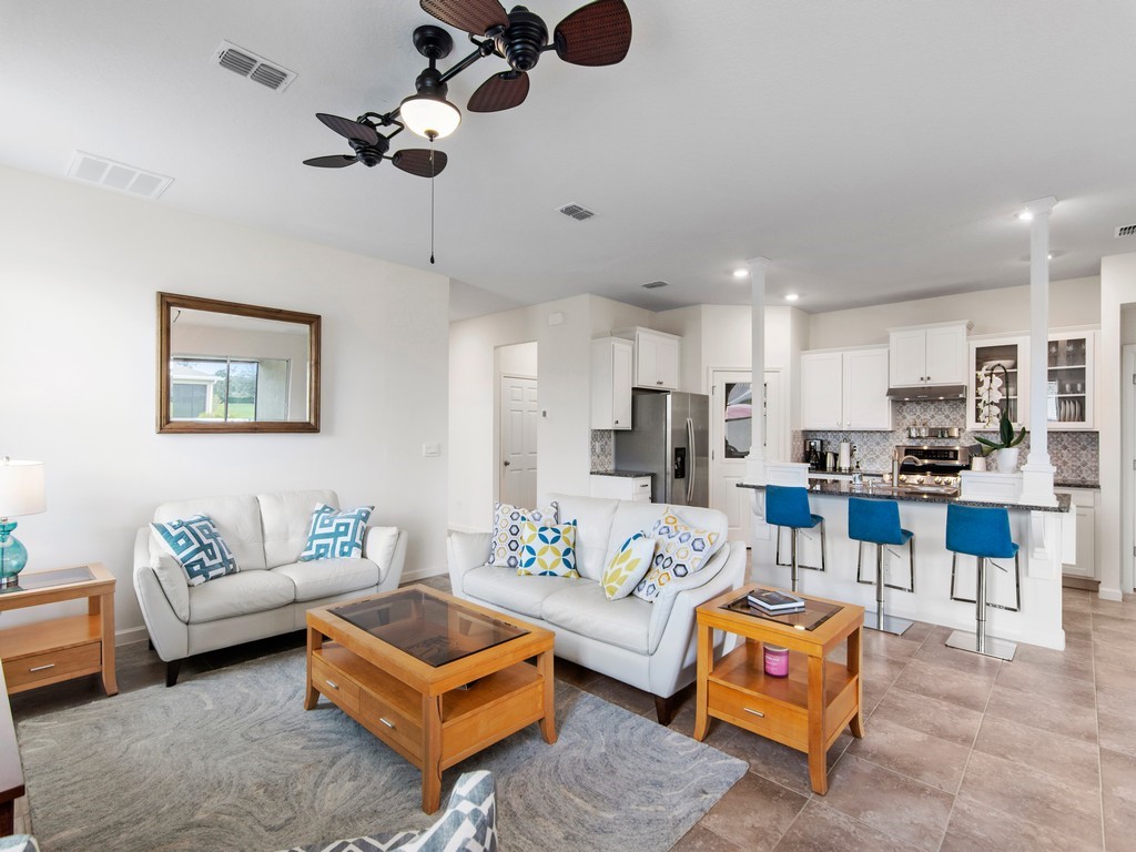 2040 Amazon Way Southwest Vero Beach, FL 32962 - Photo 2 of 35 a living room with furniture kitchen view and a chandelier