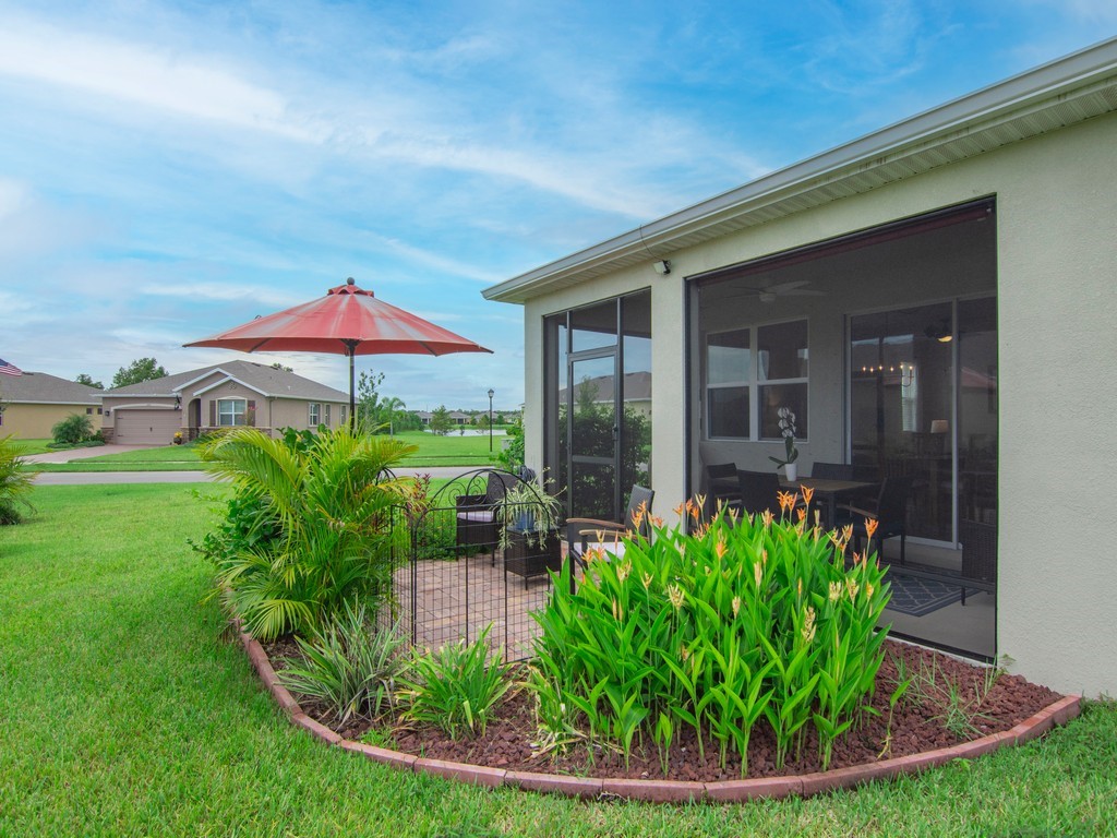 2040 Amazon Way Southwest Vero Beach, FL 32962 - Photo 23 of 35 a view of a house with backyard sitting area and porch