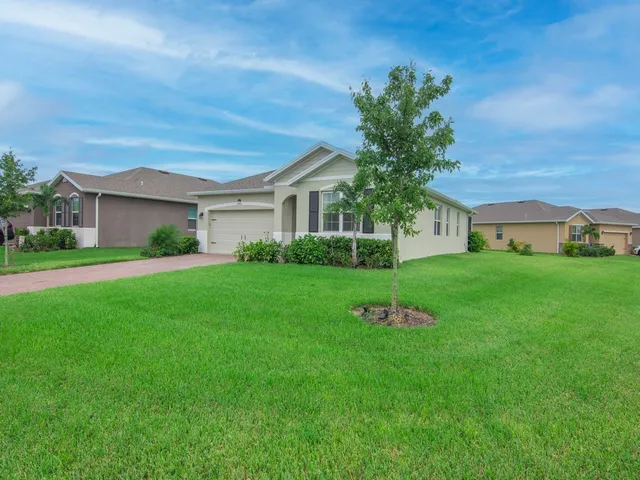 a yellow and red house with a garden