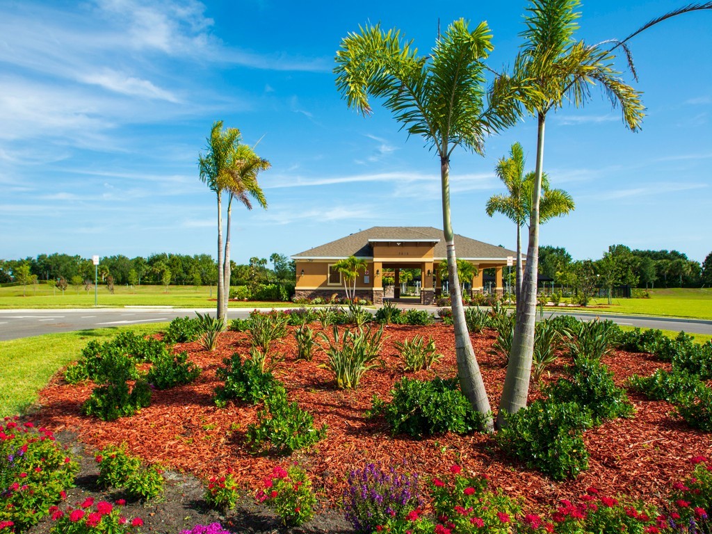 2040 Amazon Way Southwest Vero Beach, FL 32962 - Photo 29 of 35 a view of a garden with a bench and potted plants