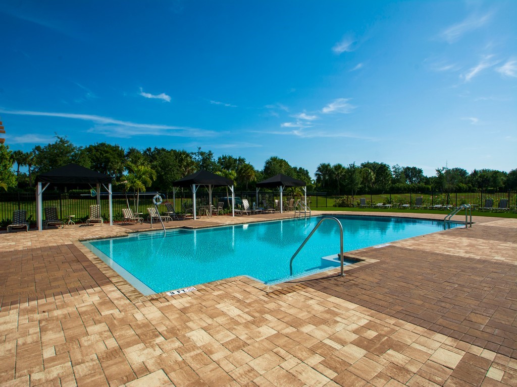 2040 Amazon Way Southwest Vero Beach, FL 32962 - Photo 30 of 35 a view of a swimming pool with a yard and large trees