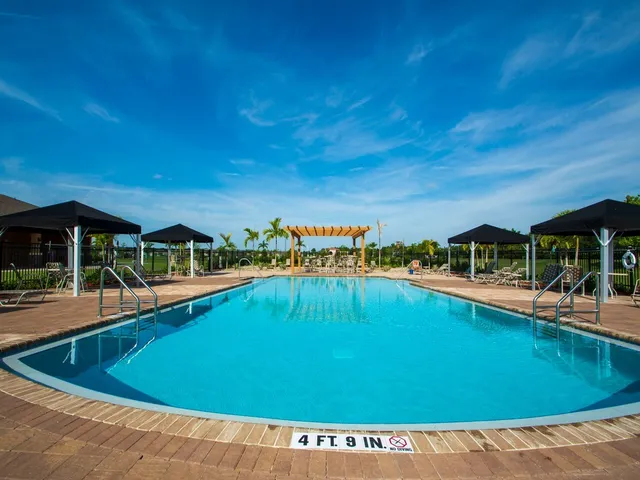 a view of a swimming pool with an outdoor seating and a yard