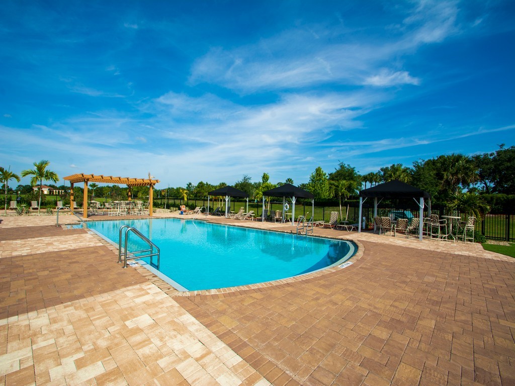 2040 Amazon Way Southwest Vero Beach, FL 32962 - Photo 34 of 35 a view of a swimming pool with an outdoor seating and a yard
