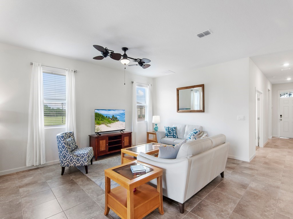 2040 Amazon Way Southwest Vero Beach, FL 32962 - Photo 4 of 35 a living room with furniture and a flat screen tv