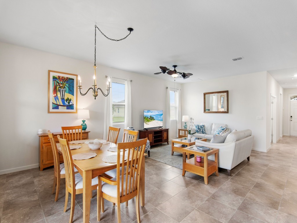 2040 Amazon Way Southwest Vero Beach, FL 32962 - Photo 10 of 35 a living room with furniture and a chandelier