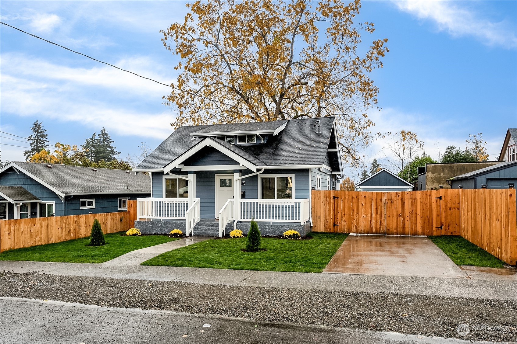 3217 South Durango Street Tacoma, WA 98409 - Photo 2 of 21 a front view of a house with a yard and a garage
