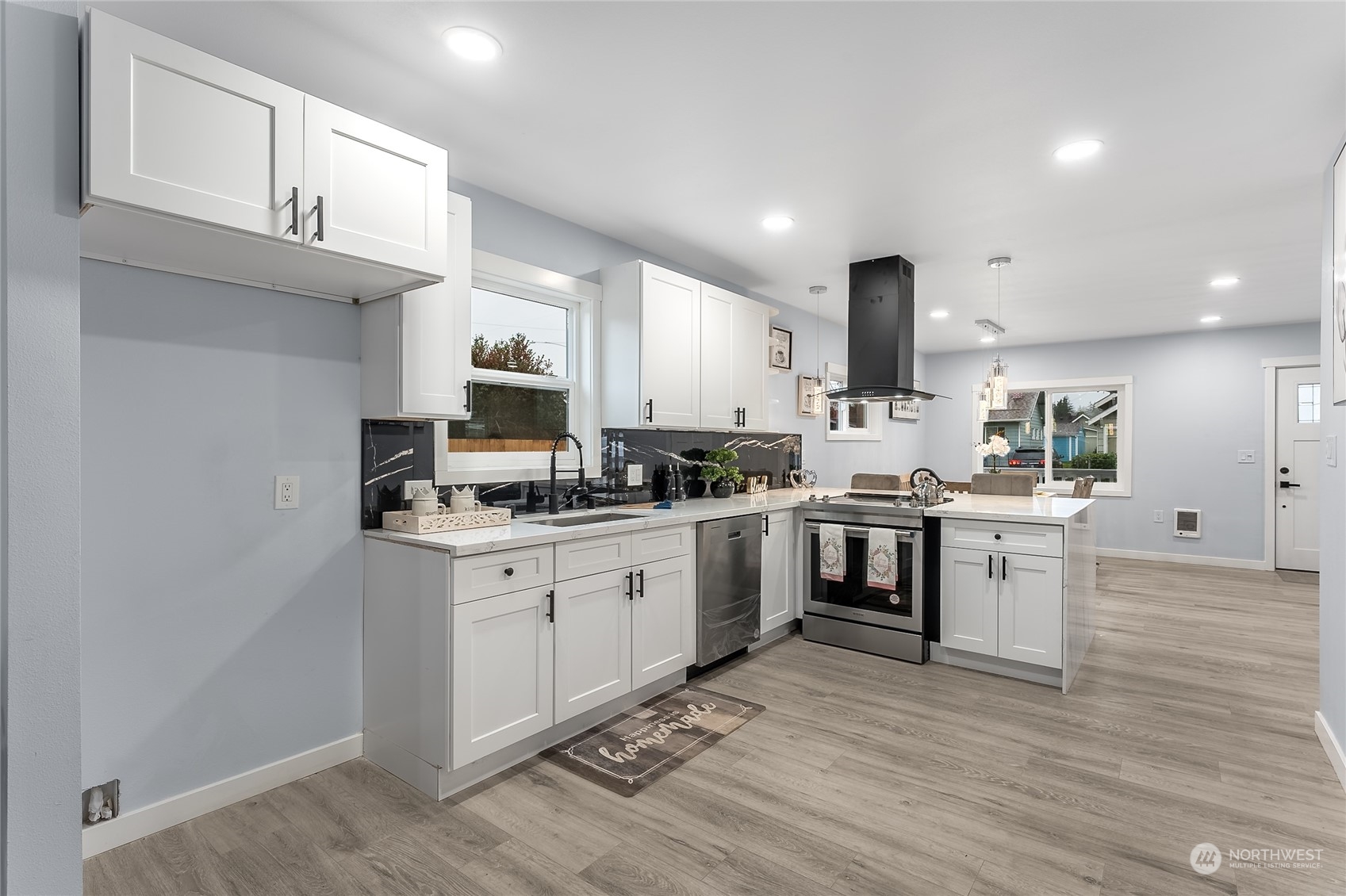 3217 South Durango Street Tacoma, WA 98409 - Photo 7 of 21 a kitchen with cabinets stainless steel appliances and wooden floor
