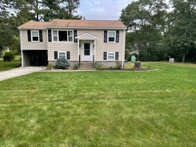 a front view of a house with a yard