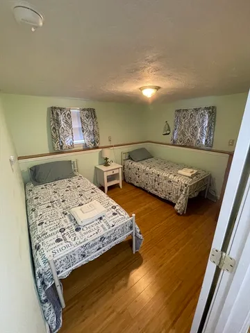 a bedroom with two beds and a desk