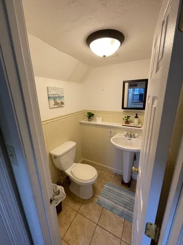 a bathroom with a sink toilet and a mirror