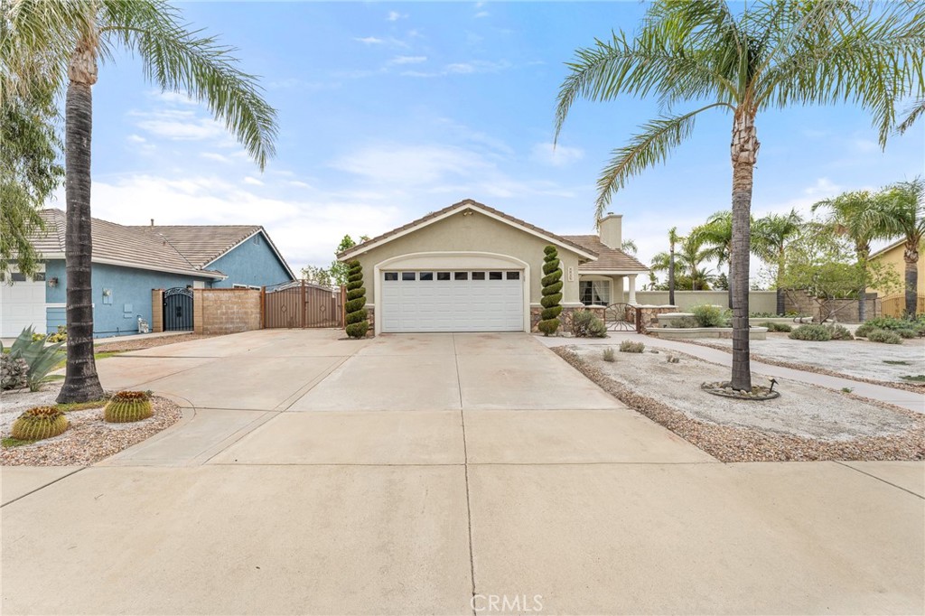 4021 North Larkspur Avenue Rialto, CA 92377 - Photo 2 of 40 a view of a house with a yard and palm trees