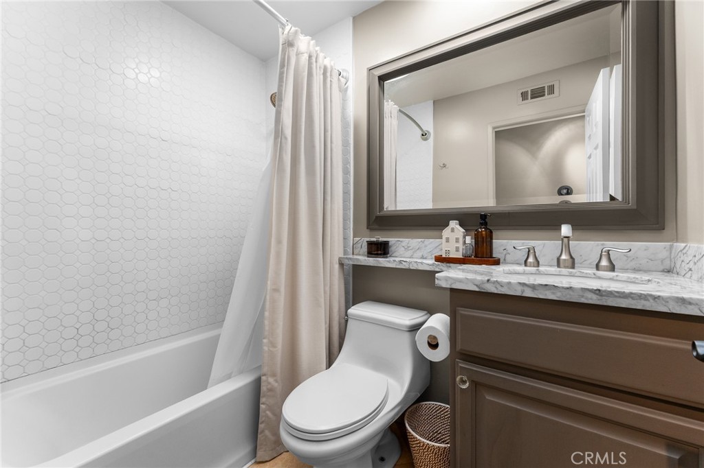 4021 North Larkspur Avenue Rialto, CA 92377 - Photo 21 of 40 a white toilet sitting next to a bathroom sink