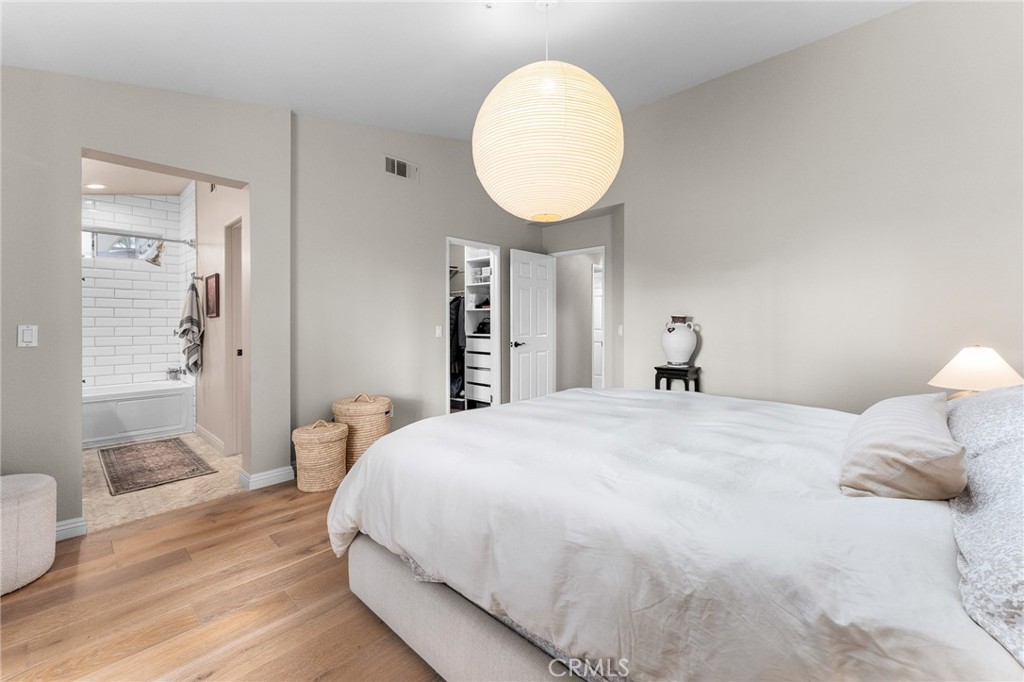 4021 North Larkspur Avenue Rialto, CA 92377 - Photo 22 of 40 a bedroom with a bed and wooden floor