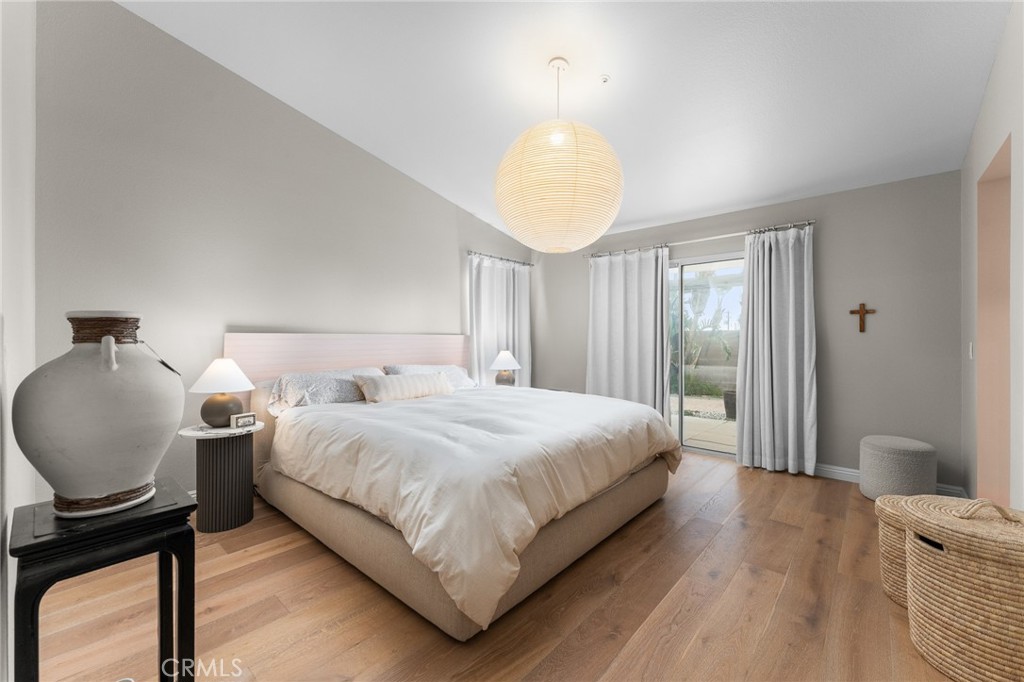 4021 North Larkspur Avenue Rialto, CA 92377 - Photo 23 of 40 a bedroom with a bed and wooden floor